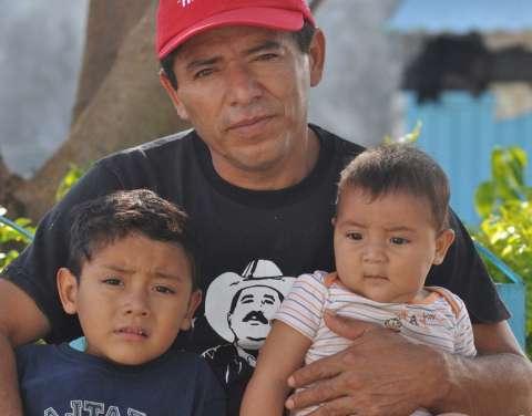 Man holding his two children